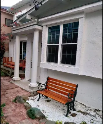 a wooden bench sitting in front of a house at \u30b6\u30b9\u30bf\u30f3\u30c0\u30fc\u30c9\u30a2\u30d1\u30fc\u30c8\u30e1\u30f3\u30c8\u6e0b\u8c37\u7b39\u585ac in Tokyo