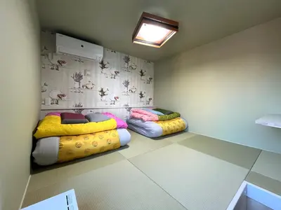 a room with two beds in a room at DainHostel2 in Tokyo
