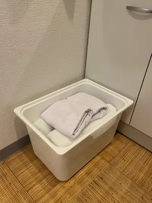a white bath tub with a towel in it at DainHostel2 in Tokyo