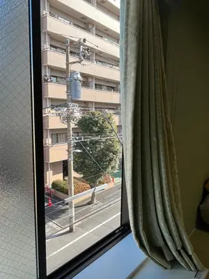 a close up of a window with a green curtain at DainHostel2 in Tokyo