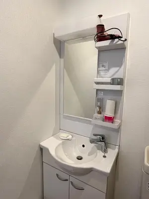 a white bathroom with a sink and a mirror at DainHostel2 in Tokyo