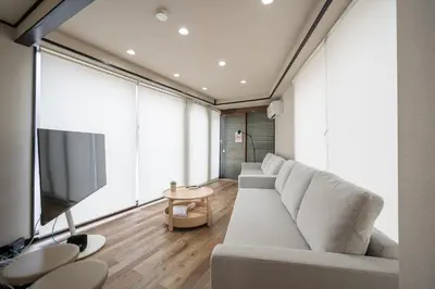 a living room with a couch and a flat screen tv at Familia Heiwajima in Tokyo