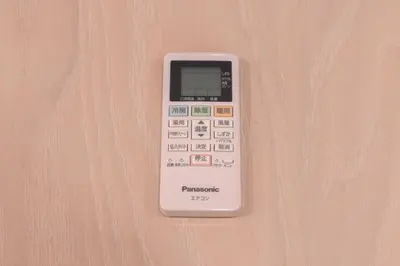 a remote control sitting on top of a table at \u30b8\u30a7\u30df\u30cb\u30b9\u6c60\u888b303 in Tokyo
