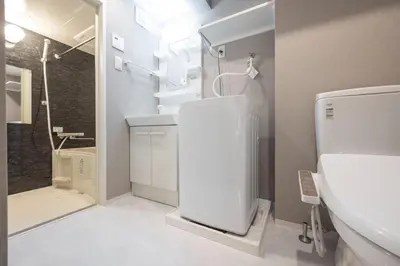 a white bathroom with a sink and a shower at ARUCiA\u99d2\u6ca2\u5927\u5b66 in Tokyo