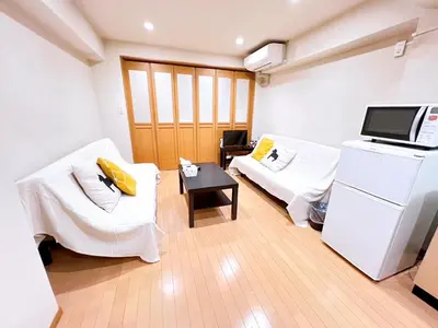 a room with two white chairs and a microwave at Brown vesel ebisu in Tokyo