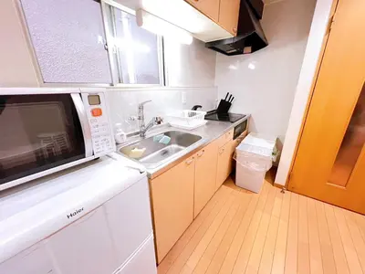 a small kitchen with a sink and a microwave at Brown vesel ebisu in Tokyo
