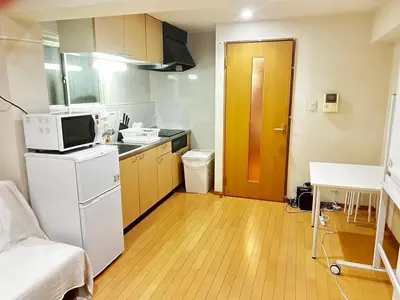 a small kitchen with a refrigerator and a microwave at Brown vesel ebisu in Tokyo