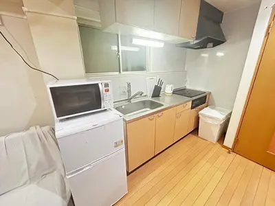 a small kitchen with a sink and a microwave at Brown vesel ebisu in Tokyo