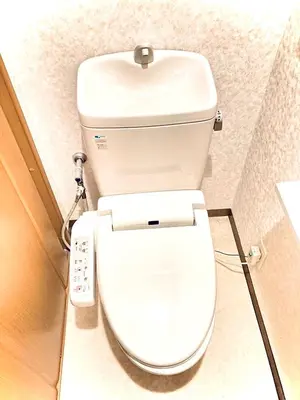a white toilet in a bathroom with a remote control at Brown vesel ebisu in Tokyo