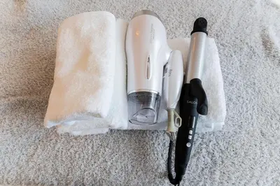 a hairdryer and a hair dryer sitting on a towel at Galicia Otsuka in Tokyo