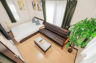 an overhead view of a living room with a couch at Japan House Oshiage in Tokyo