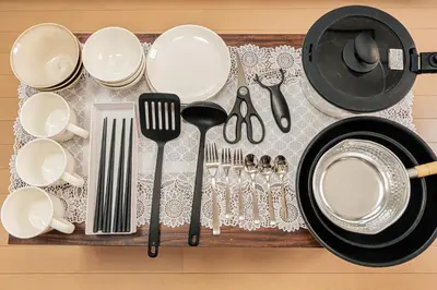a table with plates and utensils on a table at Japan House Oshiage in Tokyo