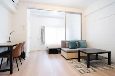 a living room with a bed and a table at \u7cf8\u3068365\u65e5 in Tokyo