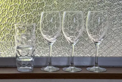 four empty wine glasses sitting on a window sill at Villa Katsushika\u304a\u82b1\u8336\u5c4b\u99c5\u5f92\u6b6910\u5206 in Tokyo