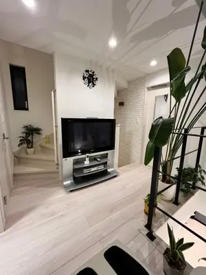 a living room with a large flat screen tv at JL \u6771\u4eac House - \u99d0\u8eca\u5834\u4ed8\u304d\u7bc9\u6d45\u306e\u307e\u308b\u3054\u3068\u8cb8\u5207\u4f4f\u5b85 in Tokyo