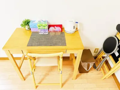 a wooden table with a chair in a room at \u30e1\u30be\u30f3\u30c9\u30ea\u30d0\u30fc\u30b8\u30e5205 in Tokyo