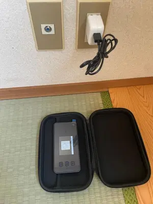 a cell phone in a black case on the floor at \u30e1\u30be\u30f3\u30c9\u30ea\u30d0\u30fc\u30b8\u30e5205 in Tokyo