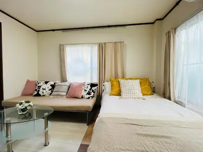 a living room with two beds and a couch at Nishi-shinjuku-ZYZ SJ0237 in Tokyo