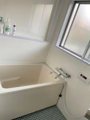 a white bath tub in a bathroom with a window at Nishi-shinjuku-ZYZ SJ0237 in Tokyo