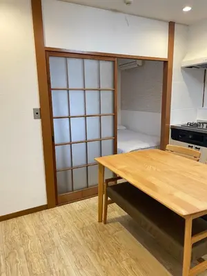 a kitchen with a wooden table and a room at Nishi-shinjuku-ZYZ SJ0237 in Tokyo