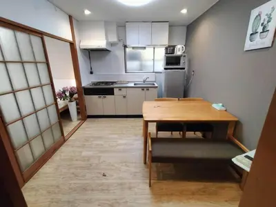 a small kitchen with a wooden table and a dining room at Nishi-shinjuku-ZYZ SJ0237 in Tokyo