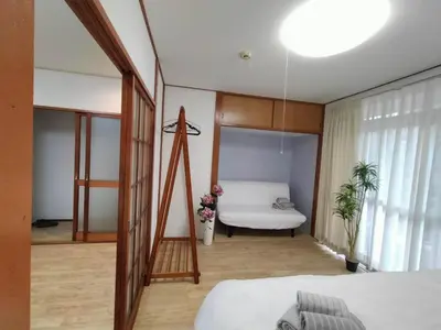 a bedroom with a bed and a table in a room at Nishi-shinjuku-ZYZ SJ0237 in Tokyo