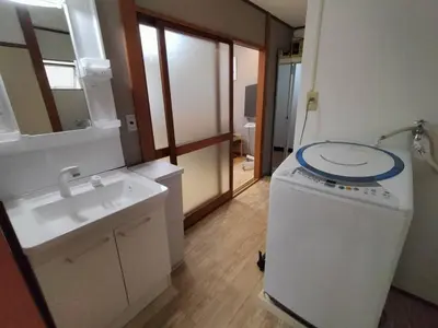 a bathroom with a sink and a washing machine at Nishi-shinjuku-ZYZ SJ0237 in Tokyo
