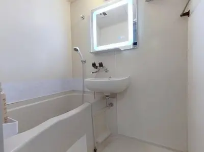 a white bathroom with a sink and a bath tub at 202 Shinjuku center- 10mins from shinjuku st a- 2mins Okubo- Max6p-2room-\u6d89\u8c37\u516d\u672c\u6728\u94f6\u5ea7\u76f4\u8fbe in Tokyo