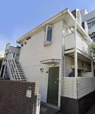 a white house with a green door and stairs at 202 Shinjuku center- 10mins from shinjuku st a- 2mins Okubo- Max6p-2room-\u6d89\u8c37\u516d\u672c\u6728\u94f6\u5ea7\u76f4\u8fbe in Tokyo