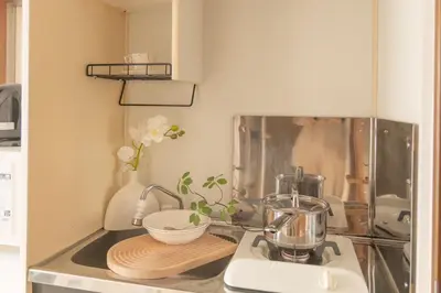 a kitchen counter with a mixer and a bowl on a cutting board at Lucky House\u65b0\u5bbf11 in Tokyo