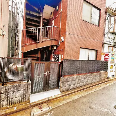 a building with a fence and a staircase on it at Lucky House\u65b0\u5bbf22 in Tokyo