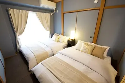 a hotel room with two beds and a window at \u30d3\u30b9\u30bf\u6c60\u4e0a 301 in Tokyo