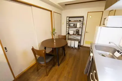 a small kitchen with a table and a refrigerator at \u30d3\u30b9\u30bf\u6c60\u4e0a 301 in Tokyo