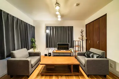 a living room with two chairs and a couch at 29, Omori-kita, Private house rental, \u5927\u68ee\u5317 in Tokyo