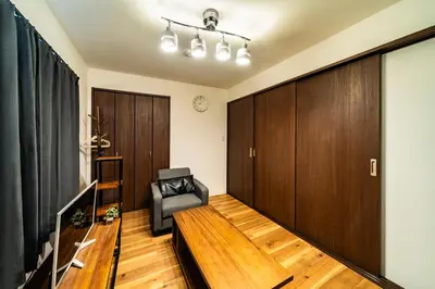 a living room with a couch and a chair at 29, Omori-kita, Private house rental, \u5927\u68ee\u5317 in Tokyo