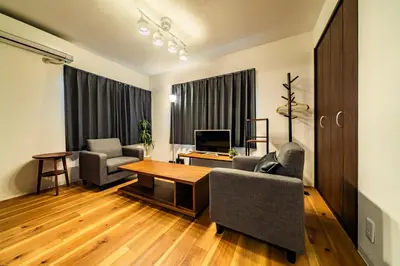 a living room with two chairs and a table at 29, Omori-kita, Private house rental, \u5927\u68ee\u5317 in Tokyo