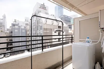 a balcony with a view of a city at Shinjuku Kabukicho Harmony Inn in Tokyo