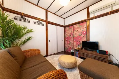 a living room with a couch and a tv at Shinjuku , 3min walk Okubo Sta, net, PocketWi-Fi, Switch in Tokyo