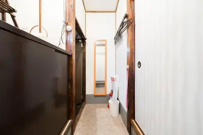 a hallway with a bathroom with a toilet in it at Shinjuku , 3min walk Okubo Sta, net, PocketWi-Fi, Switch in Tokyo