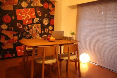 a dining room table with chairs and a laptop on it at Akihabara Area! Direct to Shibuya, Narita, Haneda in Tokyo