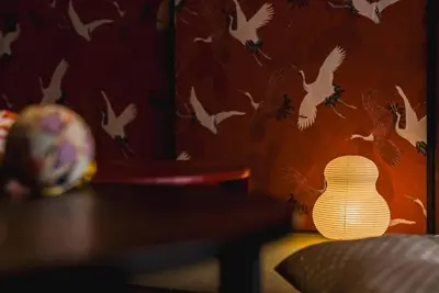 a lamp sitting on a table with birds on a wall at Akihabara Area! Direct to Shibuya, Narita, Haneda in Tokyo
