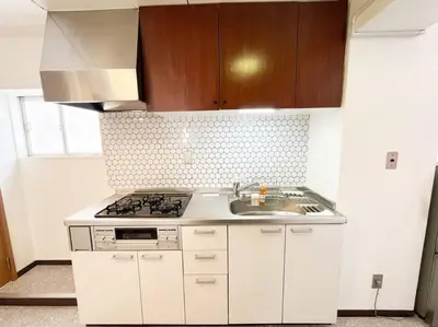 a white kitchen with a sink and a stove at Akihabara Area! Direct to Shibuya, Narita, Haneda in Tokyo