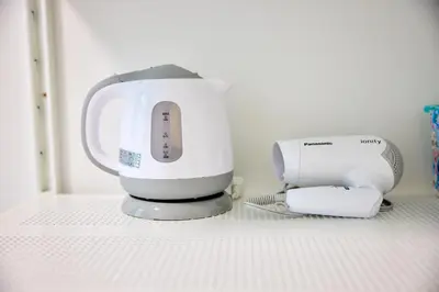 a white appliance sitting on top of a shelf at \u5bbf\u6816\u6e0b\u8c37 in Tokyo