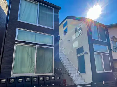 a building with the sun shining behind it at \u5bbf\u6816\u6e0b\u8c37 in Tokyo