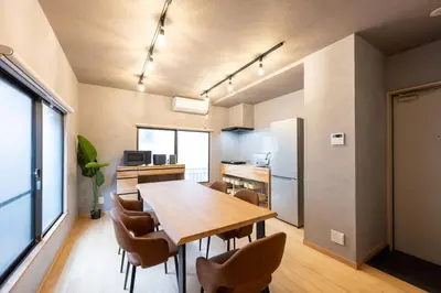 a kitchen and dining room with a wooden table and chairs at \u3075\u3046\u308d\u3046 Furo in Tokyo