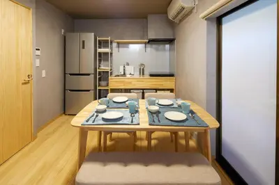a kitchen with a table with plates on it at \u3075\u3046\u308d\u3046 Furo in Tokyo