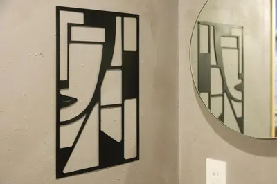 a wall with a mirror and a painting on it at \u3075\u3046\u308d\u3046 Furo in Tokyo