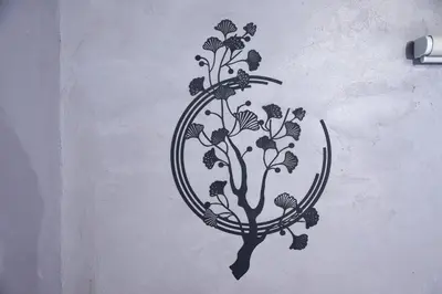 a stencil of a tree with flowers on a wall at \u3075\u3046\u308d\u3046 Furo in Tokyo