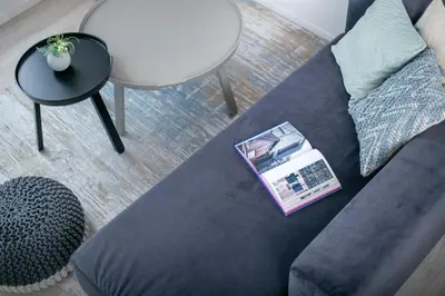 a blue couch with a box on it in a living room at \u3077\u3075\u304b\u6771\u5411\u5cf62 in Tokyo