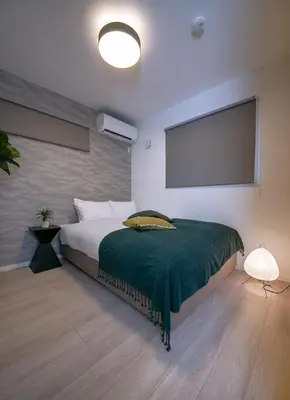 a bedroom with a bed and a flat screen tv at \u3077\u3075\u304b\u6771\u5411\u5cf62 in Tokyo